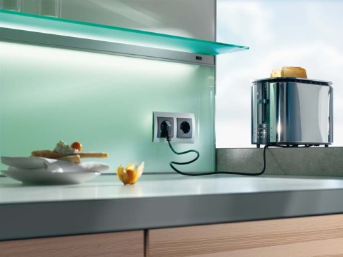 kitchen-rear-wall-has-a-backlit-glass-niche-with-integrated-socket